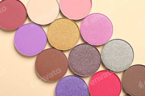 Preview: Different beautiful eye shadows on beige background, flat lay