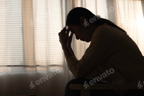 Preview: Female having depression sitting alone in bedroom dark corner. woman headache unhappy emotion.