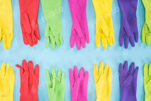 Preview: flat lay with multicolored rubber gloves on blue background