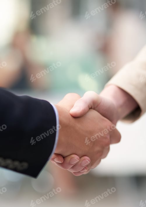 Preview: Business meetings. Shot of a coworkers shaking hands in an office.