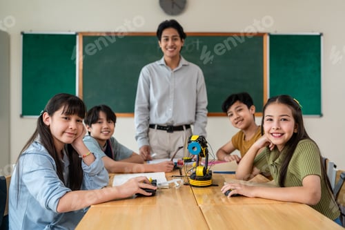 Visualização: Portrait group of students learn with teacher in classroom at school.