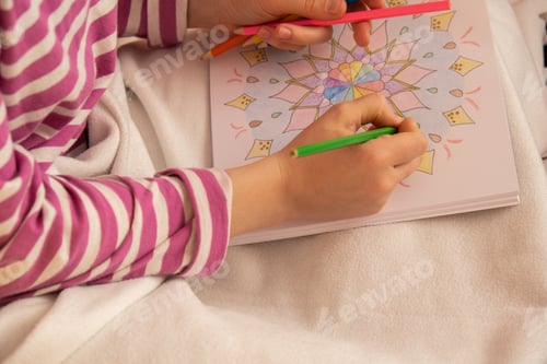 Preview: Woman coloring antistress page. Female hand painting mandala. Female painting mandalas to combat str