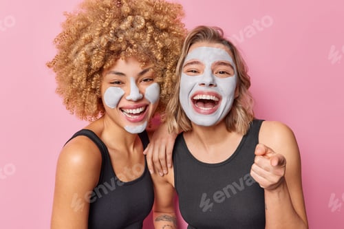 Preview: Women Laughing with Facial Mask Against Pink Background