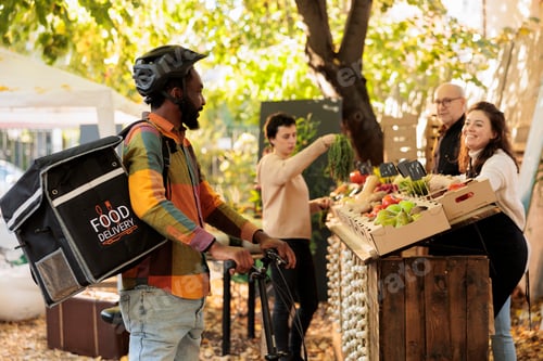 Preview: African delivery guy waiting for order at farmers market