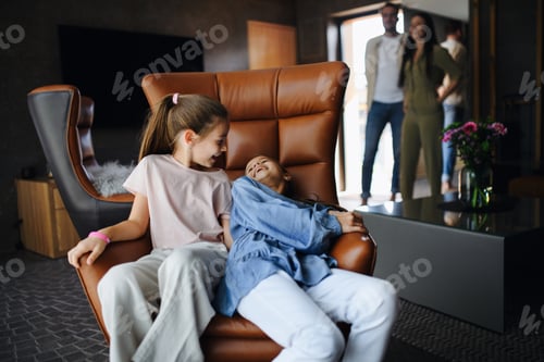 Preview: Happy two sisters with parents enjoying time at luxury hotel, summer holiday