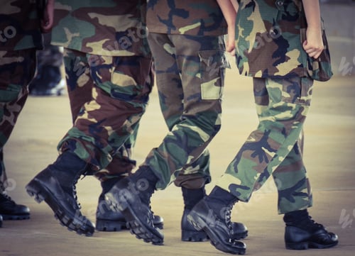 Preview: Four Figures Walking in Step Wearing Camouflage Clothing