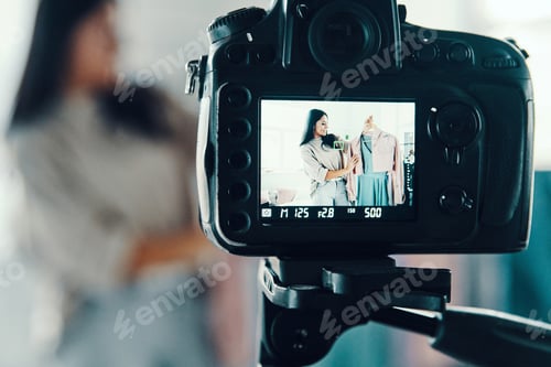 Preview: Beautiful young woman in casual clothing making social media video while spending time at home