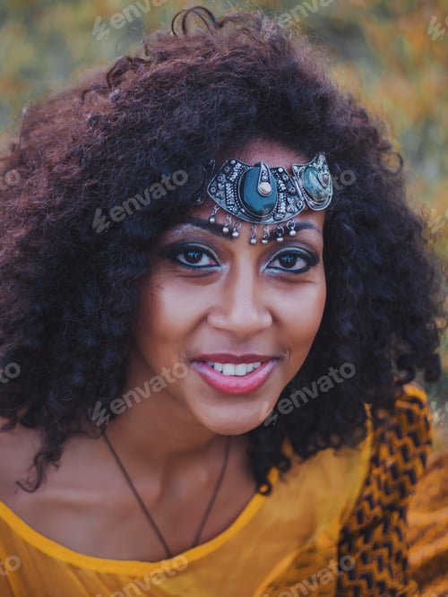 Preview: Beautiful Afro American woman in colorful dress posing outdoors