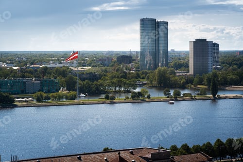 Preview: Aerial skyline view of West Bank of Daugava (Pardaugava) and Latvian Flag - Riga, Latvia