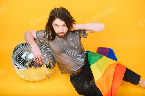 Preview: Youth transgender LGBT with Rainbow flag on shoulder isolated color background.