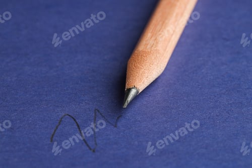 Preview: Drawing strokes with graphite pencil on blue background, closeup