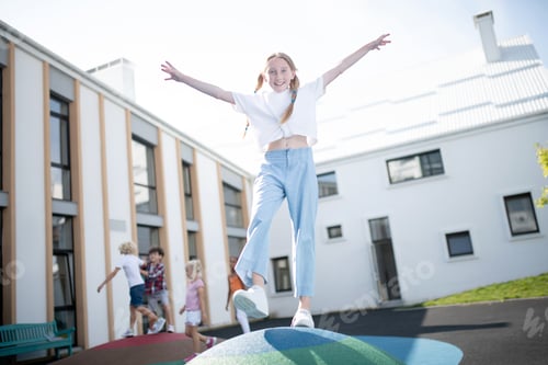 Preview: Cheerful schoolgirl playing outside on school break