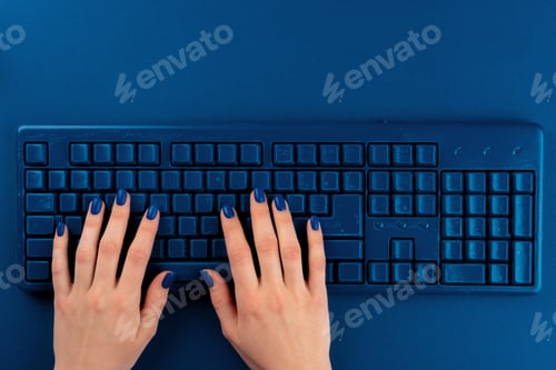 Preview: Woman hands typing on computer keyboard on classic blue background