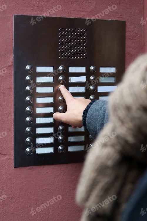 Preview: unrecognizable person ringing doorbell with blank name plate