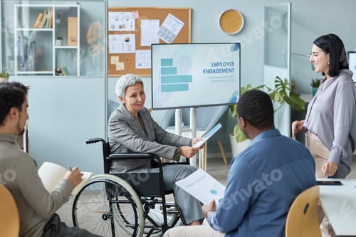 Preview: Mature businesswoman with disability in meeting
