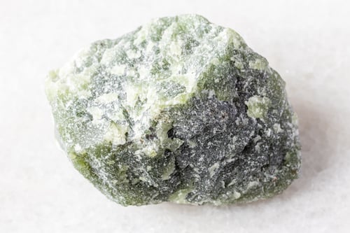 Preview: sample of raw green nephrite mineral on white