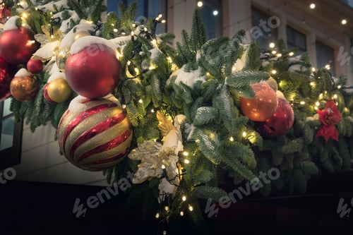 Preview: Decorated Christmas tree with red, golden balls, garland. Outdoor fair.