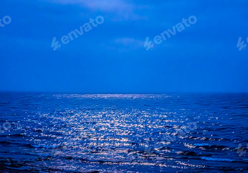 Preview: Calm ocean waters with gentle rolling waves at night