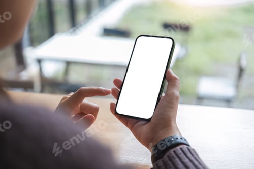Preview: Mockup image of closeup woman hand holding mobile phone with blank white smartphone screen at the