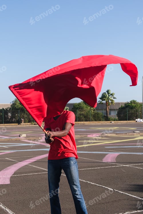 Preview: Unknown man waving the flag of his team as support in the competition