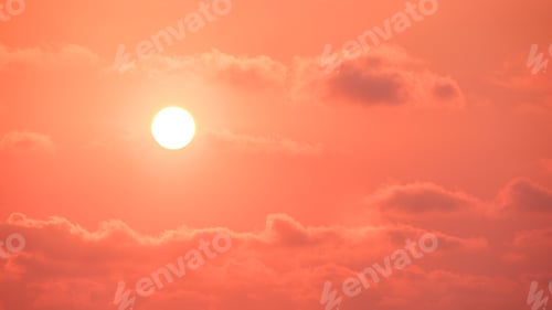 Preview: Sunset sky background with golden sun and clouds on idyllic orange evening sky