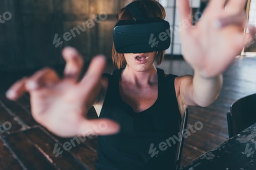 Preview: Young woman indoor using 3d goggles