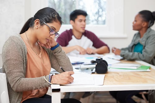 Preview: Cropped shot of three university students studying
