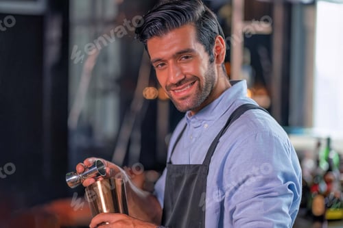 Preview: bartender smile holding in hands a steel shaker