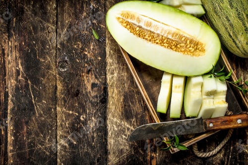 Preview: Sliced pieces of ripe melon on an old tray.