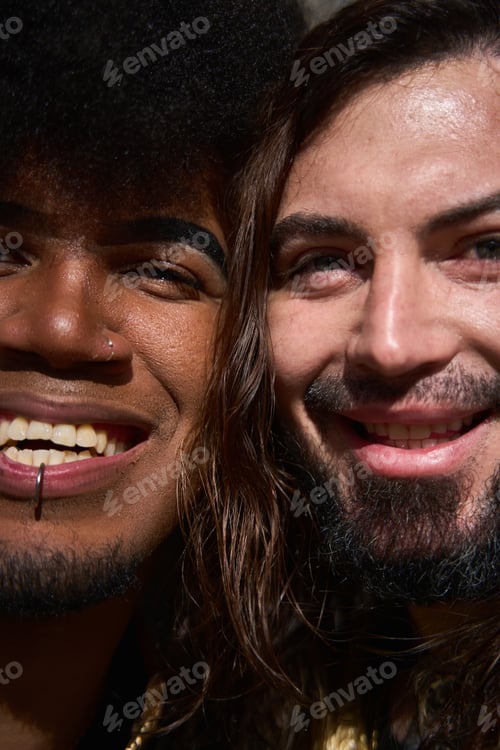 Preview: Happy gay couple smiling and showing piercings