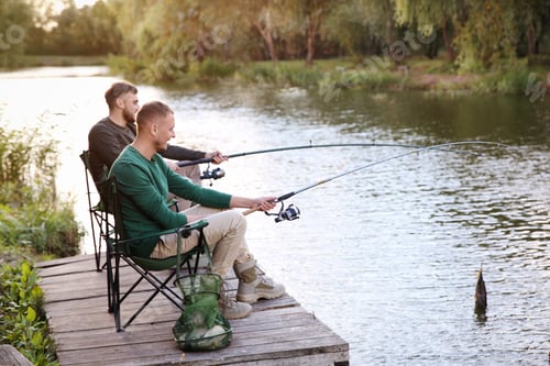 Preview: Friends fishing on wooden pier at riverside. Recreational activity