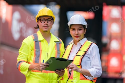 Preview: Workers inspect cargo containers at a shipping yard during daytime activities