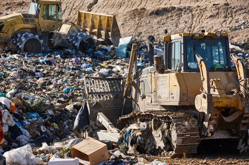 Preview: Heavy machinery shredding garbage in an open air landfill. Waste