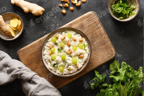 Preview: Curd Rice with pomegranate, cilantro, ginger on a black background.