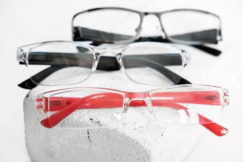 Preview: three various eyeglasses on trendy stone. Optical store, glasses selection, eye test, vision