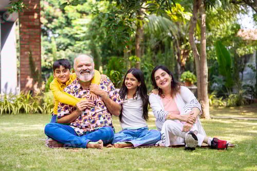 Preview: Happy Indian grandparents and children enjoying outdoor bonding time in park