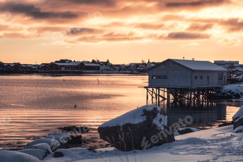 Preview: Cottage with fishing village on coastline at sunset in Lofoten islands