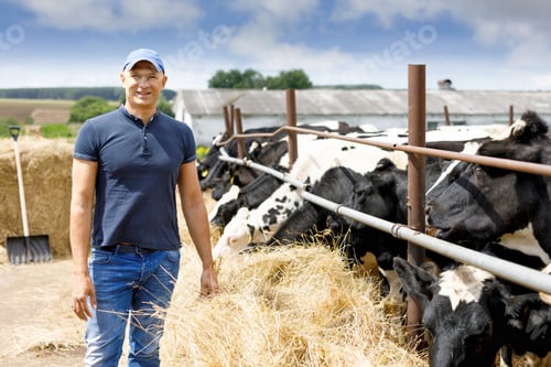 Preview: Farmer On Farm With Dairy Cow