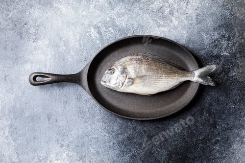 Preview: Fresh uncooked Dorado or sea bream fish in the pan