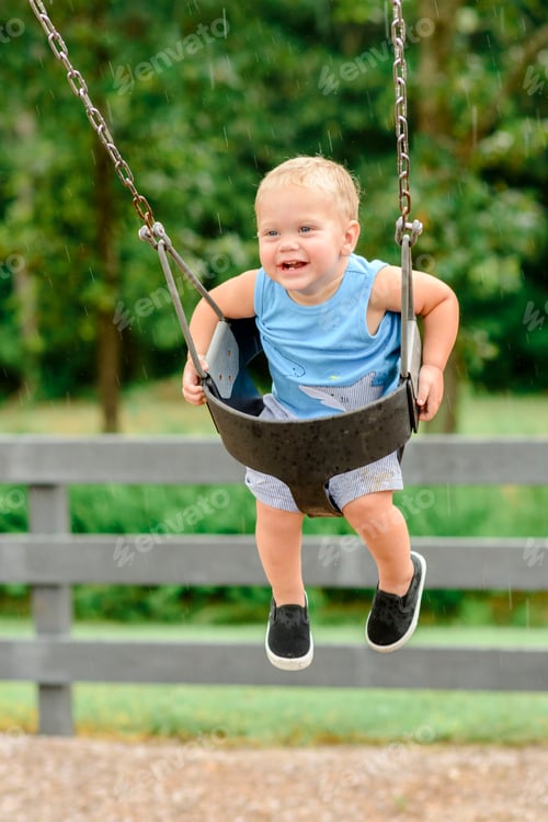Preview: Toddler boy swinging at the park