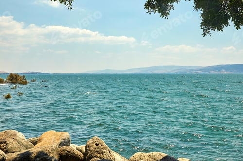 Preview: View of the Sea of Galilee with a pleasure boat from the east side on a summer sunny day, July