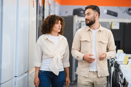 Preview: Couple choosing home appliances in electronics store