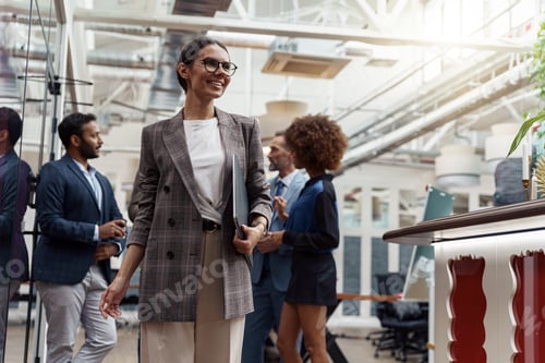 Preview: Portrait of smiling businesswoman in glasses standing in modern office on colleagues background