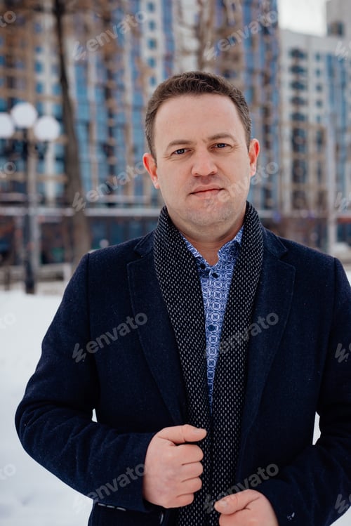 Preview: Portrait Male businessman looking at the camera stands in the city, high-rise buildings and lanterns