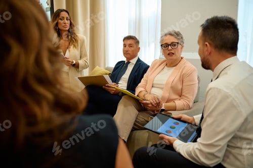 Preview: Business professionals discussing data analysis during office meeting