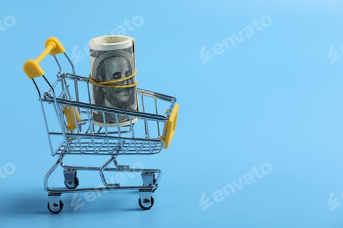 Preview: shopping time. dollars roll in shopping cart on blue background. time is money. Time management