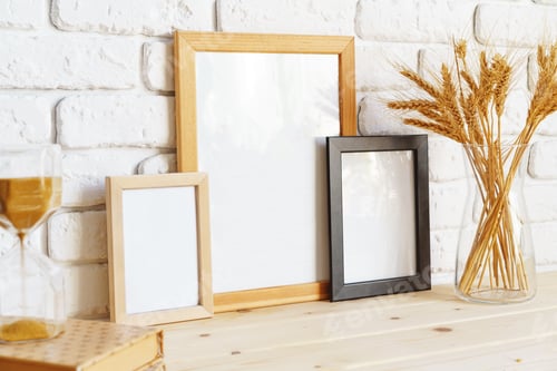 Preview: Photo frames on a brick wall background on the table with wheat ears in vase