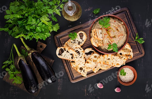 Preview: Baba ghanoush vegan hummus from eggplant with seasoning, parsley and toasts.