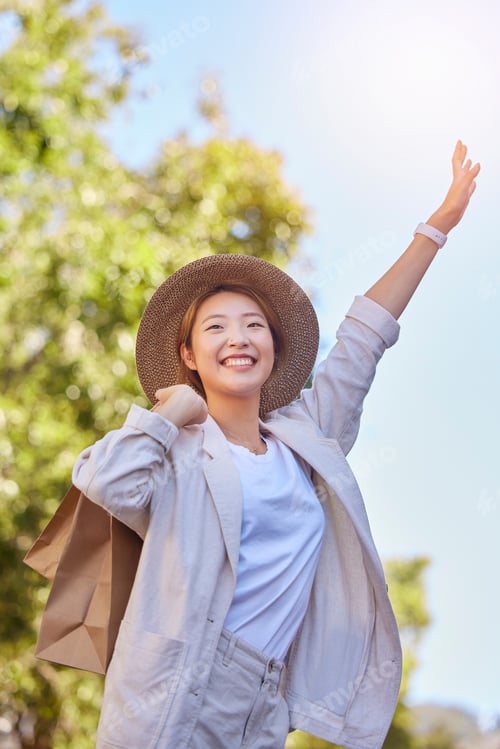 Preview: Asian woman, shopping bag and stop taxi in city outdoor after buying clothing in town. Travel, sale