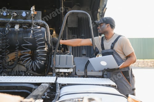 Preview: Truck repair service. African american Mechanic makes computer diagnostic of the semitruck
